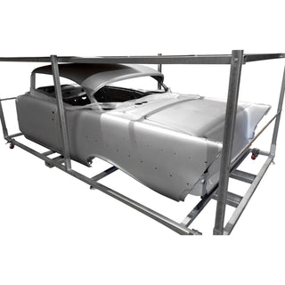 Car chassis on a metal frame against a white background. 1957 Chevy Hardtop Body Shell.