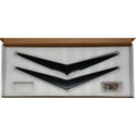 Black decorative items in a box with a white interior. 1956 Chevy Hood and Trunk Vee Set, Matt Black.