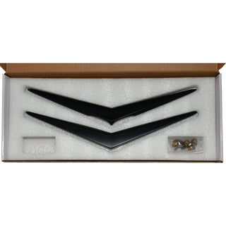 Black decorative items in a box with a white interior. 1956 Chevy Hood and Trunk Vee Set, Matt Black.