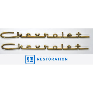 Two gold Chevrolet emblems with GM Restoration logo on a white background. 1957 Chevy 6 Cylinder Car, Chevrolet Script 15", Gold.