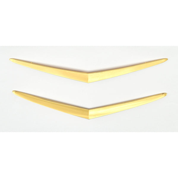 Two gold V-shaped objects on a white background. 1957 Chevy Hood and Trunk Vee Set, Gold.