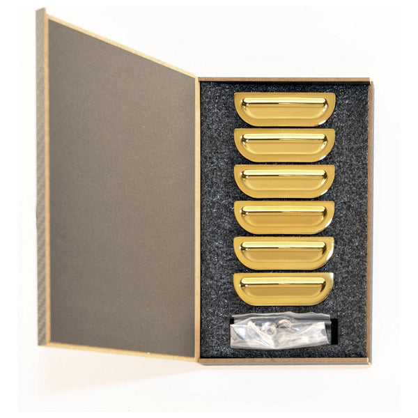 Set of gold drawer pulls in a box on a white background. 1957 Chevy Fender Louver Set, Gold.