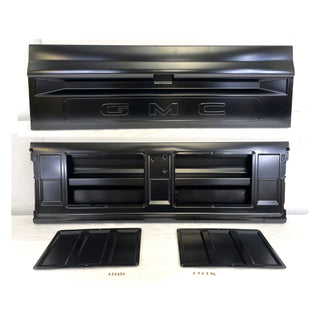 Black GMC truck grille and parts on a white background. Tailgate Fleetside With Access Panel For Tailgate Handle.