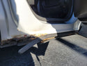 Rust and damage on a car door panel. Outer rocker panel rusted. 